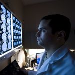Doctor views medical scans Traumatic Brain Injury