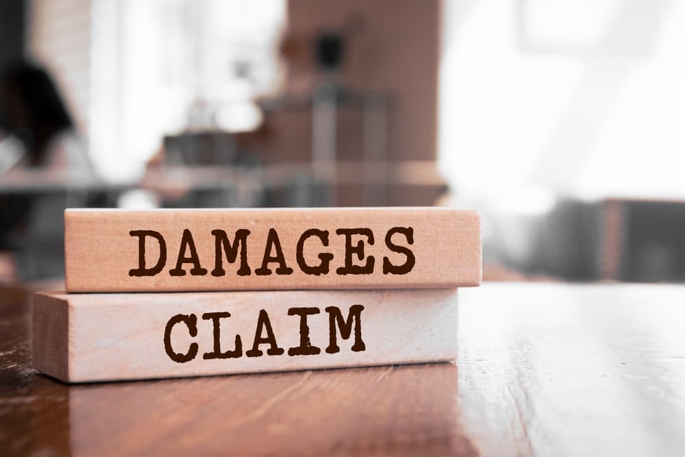 wooden blocks with words damages claim