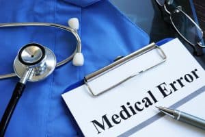 medical error report with stethoscope and doctor robe