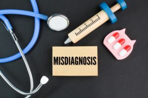 stethoscope, needle shape and medicine with the word Misdiagnosis.